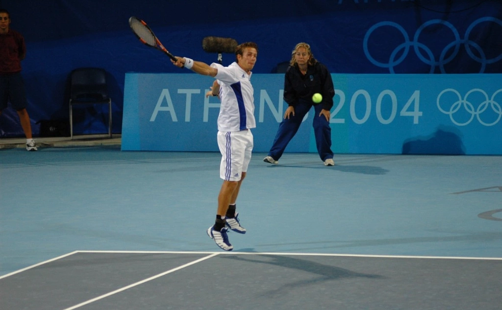 Professional tennis player Vasilis Mazarakis demonstrating forehand technique during a training session